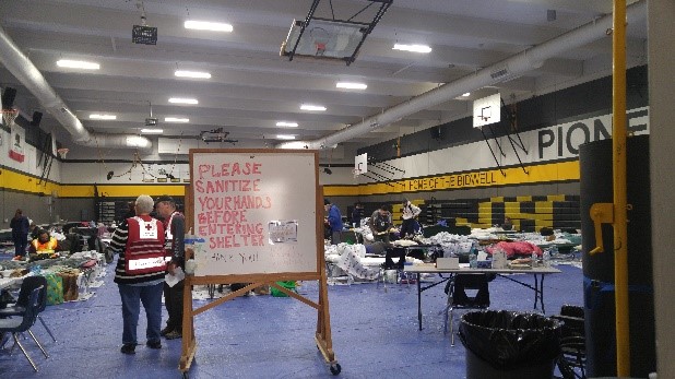 Sign in shelter stating to sanitize hands before entering