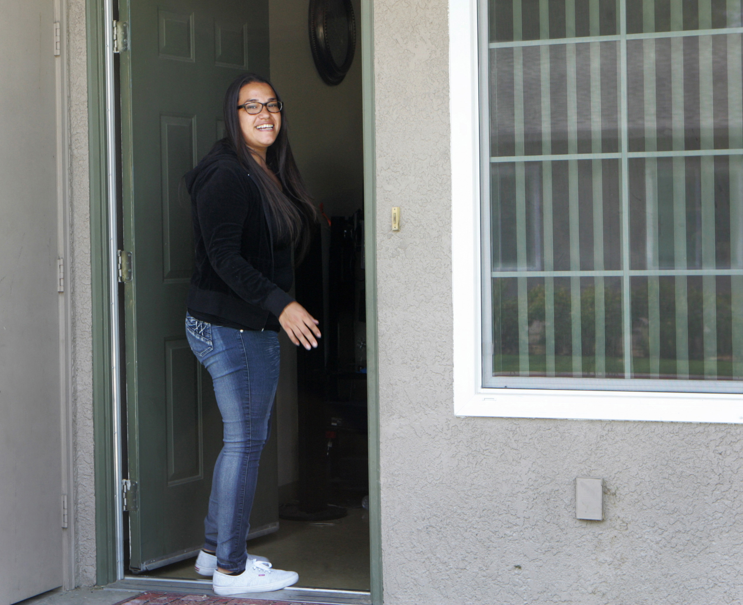 Dana Guzman by her doorway